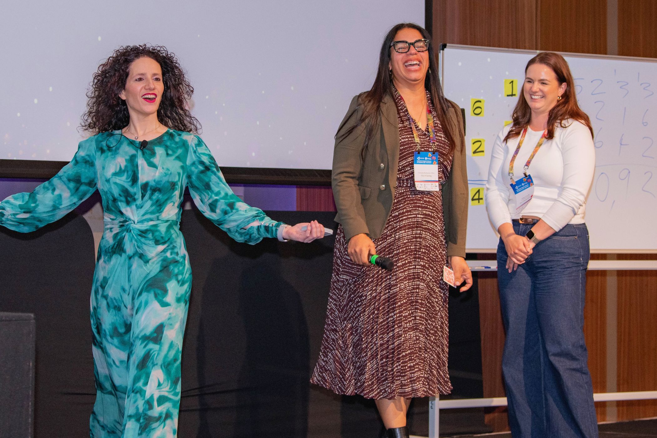 Guests laughing on stage during Jordana Borensztajn's mentalism act